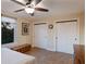 Bright bedroom with wood-look floors, ceiling fan, and double sliding-door closet at 1610 Bayshore Dr, Terra Ceia, FL 34250