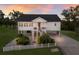 Stilt home with stairs, black roof and white picket fence at 1610 Bayshore Dr, Terra Ceia, FL 34250