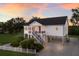 Charming stilt home with stairs, gravel driveway, and a white picket fence at 1610 Bayshore Dr, Terra Ceia, FL 34250