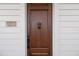 Close-up of the elegant front door with decorative hardware and a 'remove your shoes' sign at 1610 Bayshore Dr, Terra Ceia, FL 34250