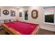 Spacious game room boasts a large pool table, comfortable seating, and picturesque views from the windows at 1610 Bayshore Dr, Terra Ceia, FL 34250