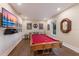 This game room features a pool table, wet bar, and mounted flat screen TV for endless entertainment at 1610 Bayshore Dr, Terra Ceia, FL 34250