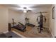 Home gym with a ceiling fan and carpet, featuring multiple exercise machines at 1610 Bayshore Dr, Terra Ceia, FL 34250