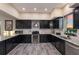 Modern kitchen featuring dark cabinets, stainless steel appliances, and a large granite countertop at 1610 Bayshore Dr, Terra Ceia, FL 34250