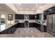 Spacious kitchen with black cabinetry, stainless steel appliances, and granite countertops at 1610 Bayshore Dr, Terra Ceia, FL 34250