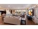 Open living area with water views, comfortable seating, piano, and a marble entertainment center at 1610 Bayshore Dr, Terra Ceia, FL 34250