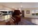 Open-concept living area featuring a grand piano, hardwood floors, and a seamless transition to the kitchen at 1610 Bayshore Dr, Terra Ceia, FL 34250