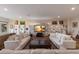 Open-concept living area featuring comfortable sofas, a fireplace and marble entertainment center at 1610 Bayshore Dr, Terra Ceia, FL 34250