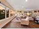 Expansive living area featuring large windows, custom shelving, and comfortable seating at 1610 Bayshore Dr, Terra Ceia, FL 34250