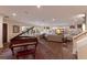 Spacious living room with built-in shelves, modern sofas, and grand piano with view at 1610 Bayshore Dr, Terra Ceia, FL 34250