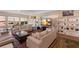 Spacious living room featuring large windows, custom shelving, a marble entertainment center, and cozy furniture at 1610 Bayshore Dr, Terra Ceia, FL 34250