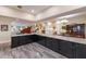 Open living space blending kitchen, dining, and living areas with marble floors and dark cabinets at 1610 Bayshore Dr, Terra Ceia, FL 34250