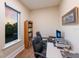 Bright office features two desks, rolling chairs, a bookcase, and a large window with a view of the outdoors at 1610 Bayshore Dr, Terra Ceia, FL 34250