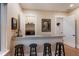 Wet bar features a granite countertop, dark cabinetry, and shelving for glasses and bar accessories at 1610 Bayshore Dr, Terra Ceia, FL 34250