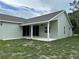Exterior view of a covered patio and backyard of a single Gathering home at 185 Wood Dove Ave, Tarpon Springs, FL 34689