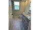 Updated bathroom with granite vanity, marble tile floors and shower at 185 Wood Dove Ave, Tarpon Springs, FL 34689