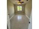 This is a cozy bedroom with a window letting in natural light and a ceiling fan at 185 Wood Dove Ave, Tarpon Springs, FL 34689