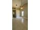 This bedroom features neutral walls, a ceiling fan, a window and tile flooring at 185 Wood Dove Ave, Tarpon Springs, FL 34689