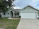 Charming single-story home with a well-manicured lawn and attached two-car garage at 185 Wood Dove Ave, Tarpon Springs, FL 34689
