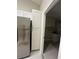 This renovated kitchen includes stainless steel appliances, white cabinets and tile floor at 185 Wood Dove Ave, Tarpon Springs, FL 34689