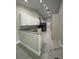 Modern kitchen featuring white cabinets, stainless steel appliances, and granite countertops at 185 Wood Dove Ave, Tarpon Springs, FL 34689
