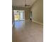 Bright living room with sliding glass doors leading to the lanai at 185 Wood Dove Ave, Tarpon Springs, FL 34689
