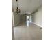 Open-concept living room with tile floors, vaulted ceilings, and lots of natural light at 185 Wood Dove Ave, Tarpon Springs, FL 34689