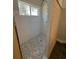 This luxurious shower has a new shower head and mosaic tile flooring at 185 Wood Dove Ave, Tarpon Springs, FL 34689