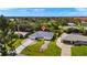 An aerial view of the home showing the surrounding neighborhood and mature trees at 19897 Midway Blvd, Port Charlotte, FL 33948