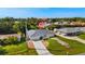 An elevated perspective showing the lovely home in a neighborhood setting with lush landscaping at 19897 Midway Blvd, Port Charlotte, FL 33948