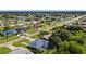 A neighborhood's aerial shot, showcasing beautiful home with pool, lush greenery, and neighborhood at 19897 Midway Blvd, Port Charlotte, FL 33948