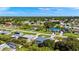 Expansive aerial view of a residential neighborhood showcasing single-Gathering homes and lush greenery under a clear blue sky at 19897 Midway Blvd, Port Charlotte, FL 33948