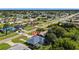 A neighborhood's aerial shot, showcasing beautiful home with pool, lush greenery, and neighborhood at 19897 Midway Blvd, Port Charlotte, FL 33948