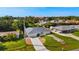 An elevated perspective showing the lovely home in a neighborhood setting with lush landscaping at 19897 Midway Blvd, Port Charlotte, FL 33948
