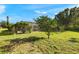 Beautiful backyard featuring a pool and an array of trees, providing a private retreat at 19897 Midway Blvd, Port Charlotte, FL 33948