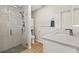 Modern bathroom featuring tiled shower with glass door, wood floors, and vanity with marble countertop at 19897 Midway Blvd, Port Charlotte, FL 33948