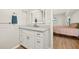 Bathroom featuring a vanity with marble countertop, an LED mirror, and wood floors at 19897 Midway Blvd, Port Charlotte, FL 33948