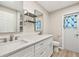 Modern bathroom features dual sinks, ample counter space, and a tiled floor at 19897 Midway Blvd, Port Charlotte, FL 33948