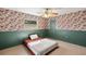 Charming bedroom features floral wallpaper, ceiling fan, and a comfortable single bed at 19897 Midway Blvd, Port Charlotte, FL 33948
