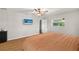 Bedroom featuring wood floors, ceiling fan, and flatscreen television at 19897 Midway Blvd, Port Charlotte, FL 33948