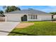 Charming single-story home featuring a well-maintained lawn and attached two-car garage at 19897 Midway Blvd, Port Charlotte, FL 33948