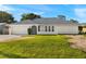 Charming single-story home featuring a well-maintained lawn and an attached two-car garage at 19897 Midway Blvd, Port Charlotte, FL 33948
