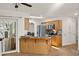 The open concept kitchen with wood cabinets features stainless steel appliances and a breakfast bar at 19897 Midway Blvd, Port Charlotte, FL 33948