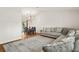 Open-concept living area featuring hardwood floors and a comfortable sectional couch at 19897 Midway Blvd, Port Charlotte, FL 33948