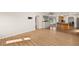 Spacious living room featuring wood floors with views of the kitchen and backyard at 19897 Midway Blvd, Port Charlotte, FL 33948