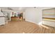 An open living room with wood floors and views of the kitchen and backyard at 19897 Midway Blvd, Port Charlotte, FL 33948