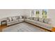Comfortable living room features a large sectional sofa and stylish area rug at 19897 Midway Blvd, Port Charlotte, FL 33948