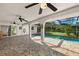 Spacious patio with stone floors, arched supports, and a screened-in pool area at 19897 Midway Blvd, Port Charlotte, FL 33948