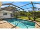 This pristine pool is enclosed with screens and surrounded by lush landscaping at 19897 Midway Blvd, Port Charlotte, FL 33948