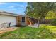 Rustic outdoor shed with exposed storage provides a great workspace for the homeowner at 19897 Midway Blvd, Port Charlotte, FL 33948